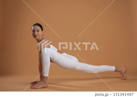 Amazing stretch. Beautiful fitness woman is in the studio Amazing stretch. Beautiful fitness woman is in the studio 131391497