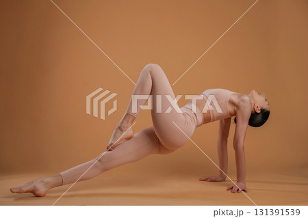 Amazing stretch. Beautiful fitness woman is in the studio 131391539