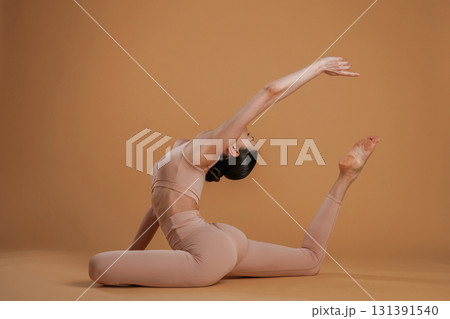 Amazing stretch. Beautiful fitness woman is in the studio 131391540