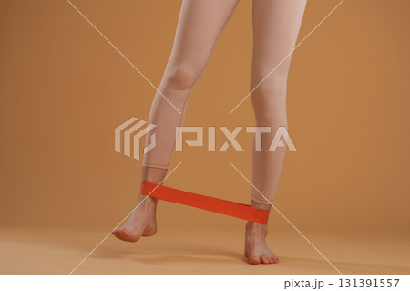 Legs of fitness woman that is in the studio, doing stretching 131391557
