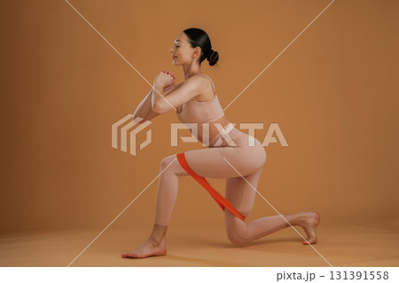 Doing squats. Beautiful fitness woman is in the studio 131391558