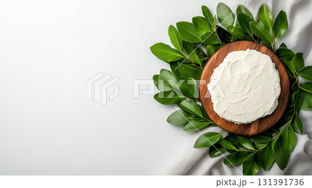 Fresh Cream Cheese Spread Decorated with Green Leaves on a Wooden Board 131391736