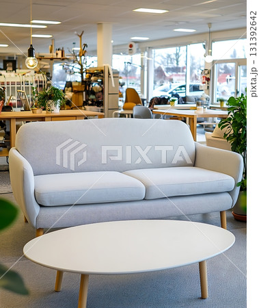 White couch is sitting in front of a white coffee table 131392642
