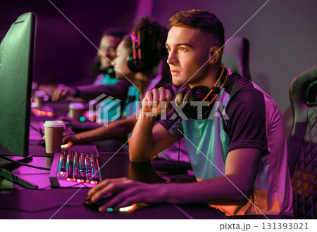 Focusing with intense concentration and determination during competitive gaming sessions Focusing with intense concentration and determination during competitive gaming sessions 131393021