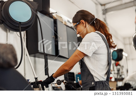 A Highly Skilled Female Mechanic Working in a Modern and Innovative Workshop Environment A Highly Skilled Female Mechanic Working in a Modern and Innovative Workshop Environment 131393081