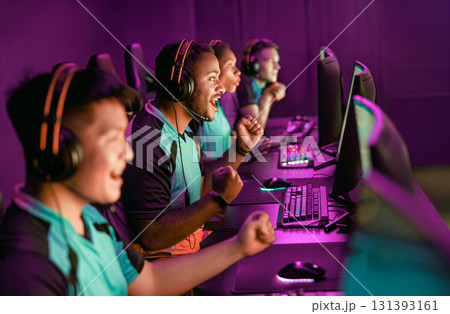 Excited Gamers Celebrating Their Team Victory in a Thrilling ESports Arena Environment 131393161