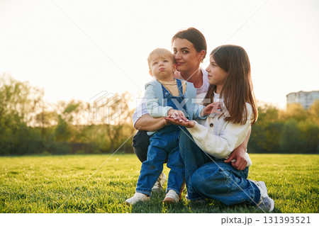 Mother with daughter and son are together on the field 131393521