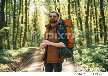 Enjoying warm weather and nature. Bearded man is in the forest at daytime 131393695