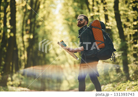 Beautiful lens effect. Bearded man is in the forest at daytime 131393743