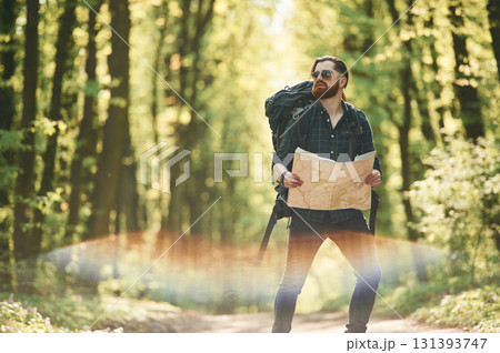 Beautiful lens effect. Bearded man is in the forest at daytime 131393747