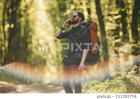 Colorful lens effect. Bearded man is in the forest at daytime Colorful lens effect. Bearded man is in the forest at daytime 131393756
