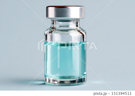 Sealed glass vial containing transparent blue liquid, showcasing the clarity and purity of the contents, ideal for pharmaceutical or laboratory applications with copy space Sealed glass vial containing transparent blue liquid, showcasing the clarity and purity of the contents, ideal for pharmaceutical or laboratory applications with copy space 131394511