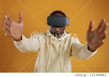 Virtual reality experience. Black guy is against yellow background 131394661
