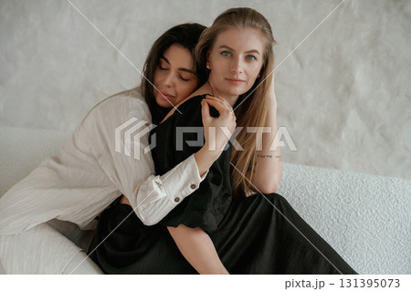 Closeness of the people. Two happy young female best friends are indoors 131395073