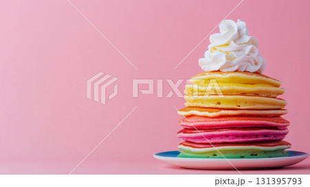 A vibrant stack of rainbow pancakes sits on a plate, beautifully topped with fluffy whipped cream, perfect for a delightful breakfast treat 131395793