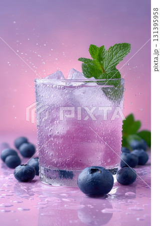 Bright and refreshing blueberry cocktail served over ice, garnished with fresh mint leaves, ideal for summer enjoyment at parties 131395958