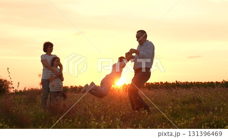 Silhouette mother father playing children, family, happiness, sunset, field, nature, outdoors, parents, children, love, joy, togetherness, bonding, summer, fun, playing, childhood, carefree, grass 131396469