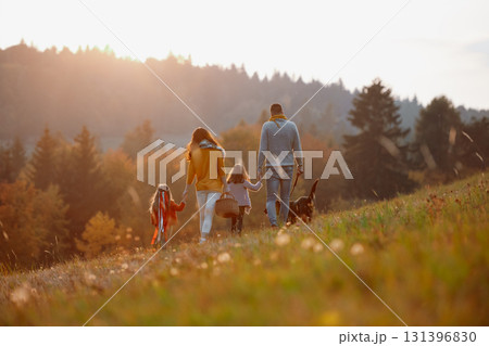Happy young family with two children in autumn nature at sunset. 131396830