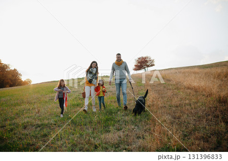 Happy young family with two children in autumn nature at sunset. Happy young family with two children in autumn nature at sunset. 131396833