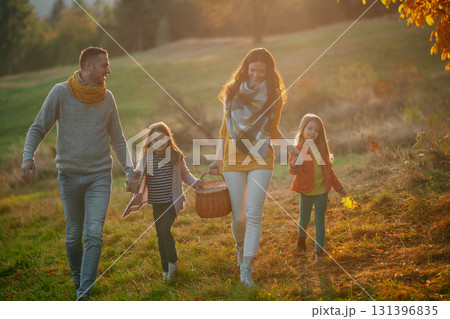 Happy young family with two children in autumn nature at sunset. 131396835