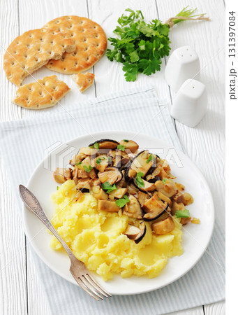 Fried porcini mushrooms with potato mash on plate 131397084
