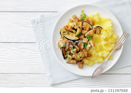 Fried porcini mushrooms with potato mash on plate Fried porcini mushrooms with potato mash on plate 131397088