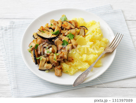 Fried porcini mushrooms with potato mash on plate 131397089