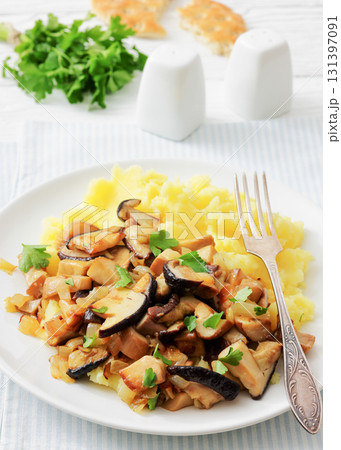 Fried porcini mushrooms with potato mash on plate Fried porcini mushrooms with potato mash on plate 131397091
