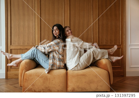 Happy playful free moments. Two young female best friends are indoors Happy playful free moments. Two young female best friends are indoors 131397295