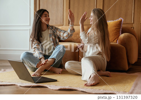Happy playful free moments. Two young female best friends are indoors Happy playful free moments. Two young female best friends are indoors 131397320