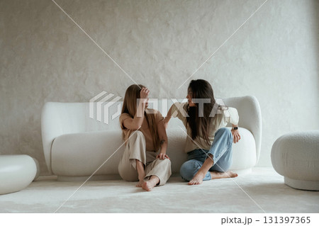 Two happy young female best friends are indoors Two happy young female best friends are indoors 131397365