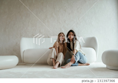 Two happy young female best friends are indoors Two happy young female best friends are indoors 131397366