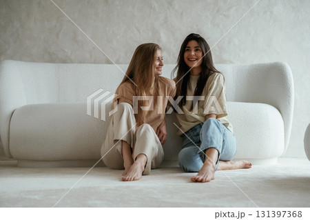 Two happy young female best friends are indoors Two happy young female best friends are indoors 131397368