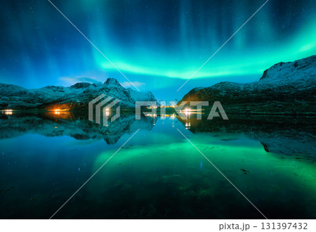 Aurora borealis and night starry sky reflected in lake in winter Aurora borealis and night starry sky reflected in lake in winter 131397432