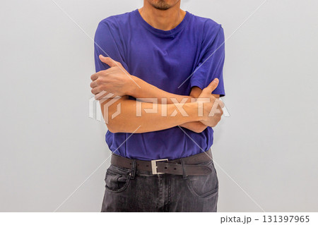 A man in a blue T-shirt stands hugging himself, frozen, calming himself down. mental pain, psychology, stress, panic, neurotic, psychiatry, illness, neurosis A man in a blue T-shirt stands hugging himself, frozen, calming himself down. mental pain, psychology, stress, panic, neurotic, psychiatry, illness, neurosis 131397965