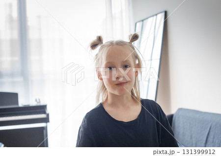 Cute child looking at camera at home. Funny face 131399912