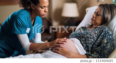 Nurse checking pregnant woman's belly during prenatal care 131400085