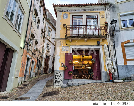 Walking along the streets in historic Coimbra, Portugal's most important university town and old capital. Baixa streets in medieval quarter. 131400980