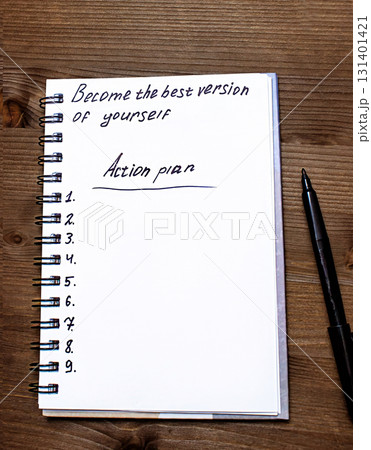 The notebook says Become the best version of yourself, top view 131401421