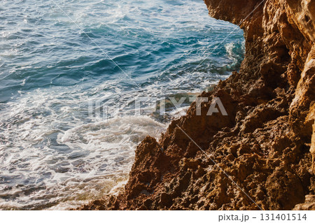 Sea and rocky Mediterranean beach, waves crashing against stones 131401514