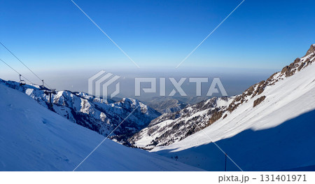 Snowy Mountain Slopes and Ski Lift on Clear Day Snowy Mountain Slopes and Ski Lift on Clear Day 131401971