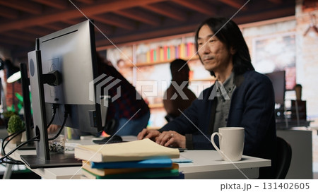 Senior admin working in innovative startup office using programming languages to build application. Experienced software development agency IT CTO supervisor optimizing code on computer, camera A 131402605