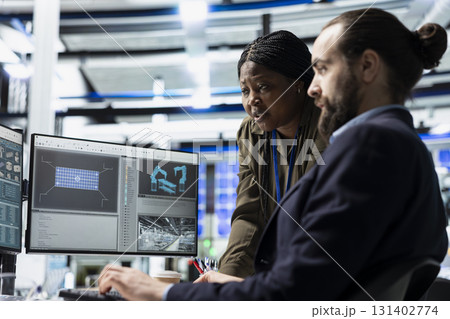 Multiethnic team of engineering specialists working together for solar power manufacturing process, strengthening infrastructure and business development. Renewable energy in a plant. Multiethnic team of engineering specialists working together for solar power manufacturing process, strengthening infrastructure and business development. Renewable energy in a plant. 131402774