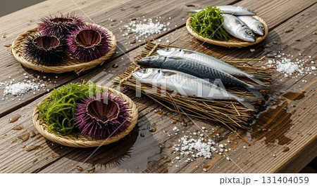 Fresh mackerel fish and purple sea urchins with seaweed arranged on wooden dock with coarse sea salt for coastal seafood preparation 131404059