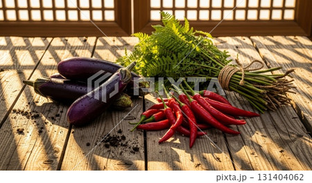 Fresh Organic Vegetables on Rustic Wooden Deck - Eggplants, Red Chili Peppers and Fern Leaves 131404062
