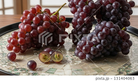 Fresh Red Grapes on Mosaic Plate with Cut Grape Cross Section 131404063