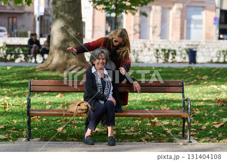 Embracing Generations: A Daughter's Love and Support for Her Senior Mother on a Sunny Day in the Park 131404108