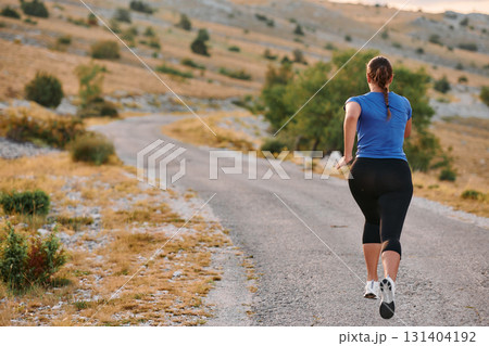 Empowered Runner Embracing Nature's Beauty on a Serene Morning Trail. Empowered Runner Embracing Nature's Beauty on a Serene Morning Trail. 131404192