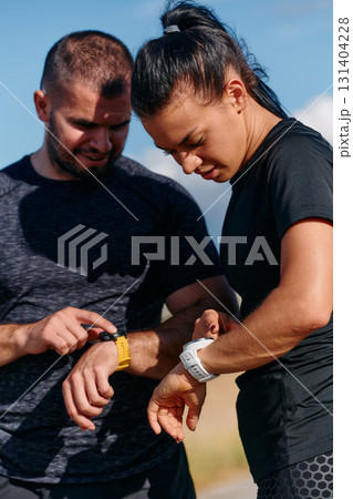 Couple Checking Running Results on Smartwatch Together Couple Checking Running Results on Smartwatch Together 131404228