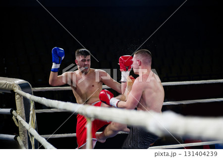 Fierce boxing match showcases athletes' power and skill. 131404239